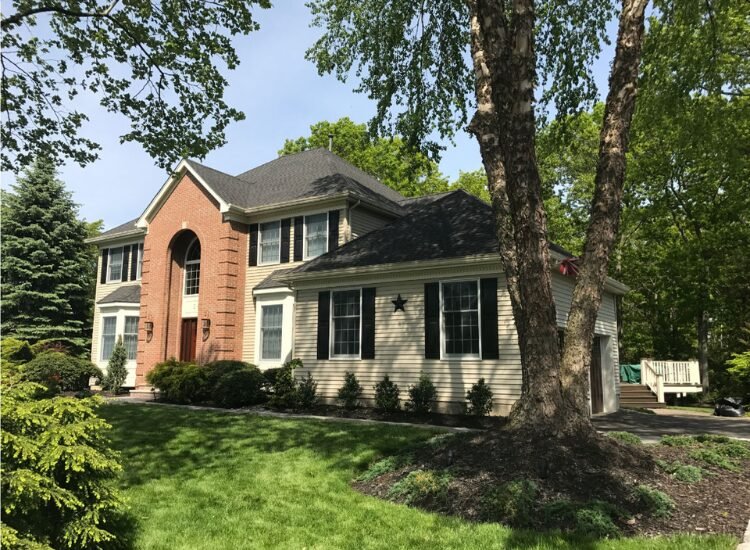 Roof Inspection Howell NJ - large home with siding and brick.