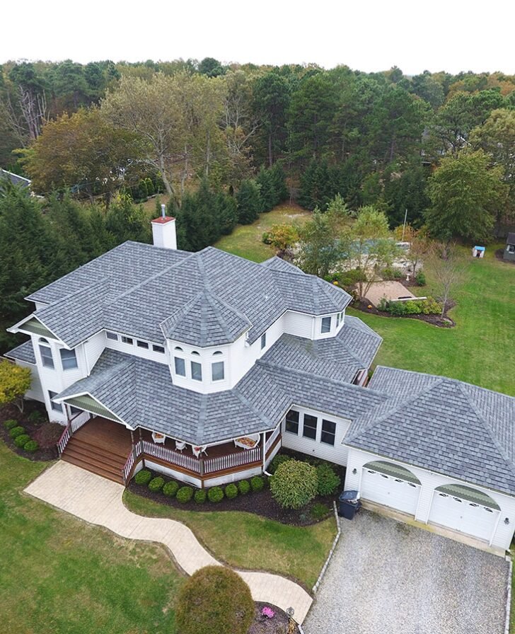 Complex roof on large home with new gray shingle roof.